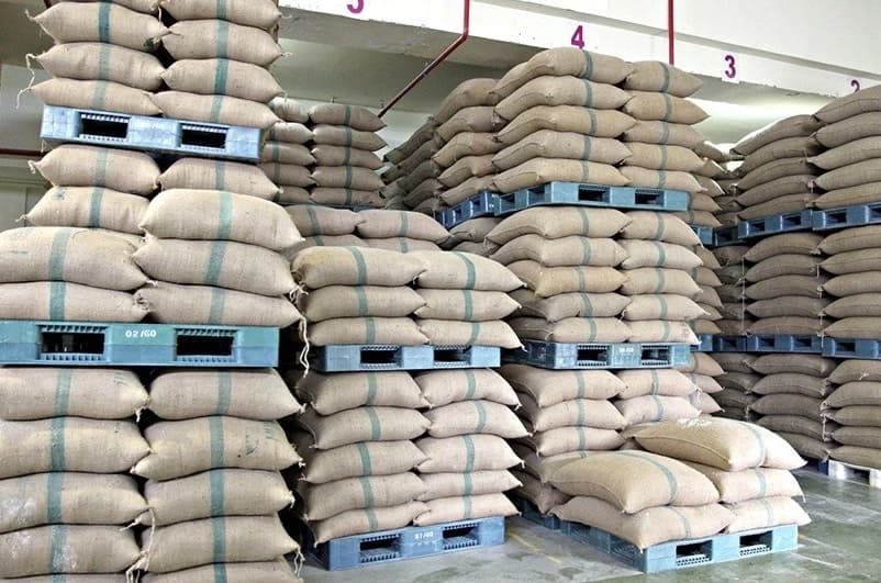 Sacks of produce stacked on pallets in an organized warehouse